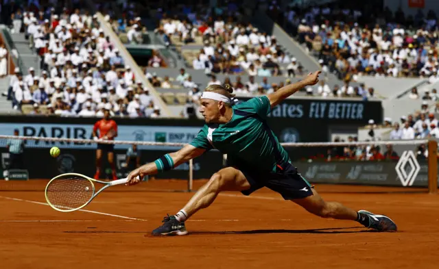 Alejandro Davidovich Fokina slides on the court to reach a ball