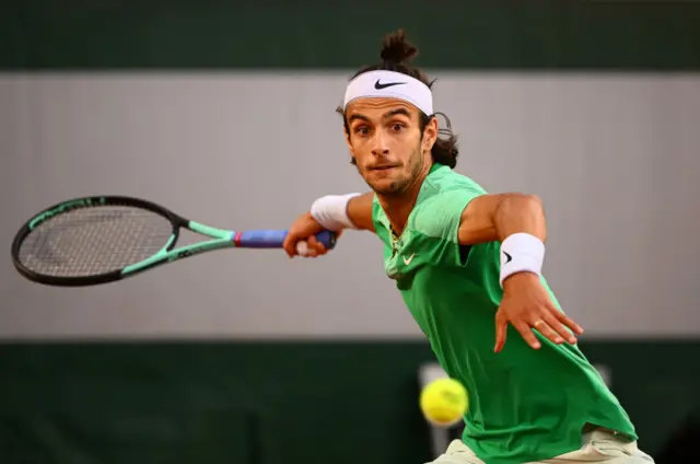 Lorenzo Musetti strikes a forehand