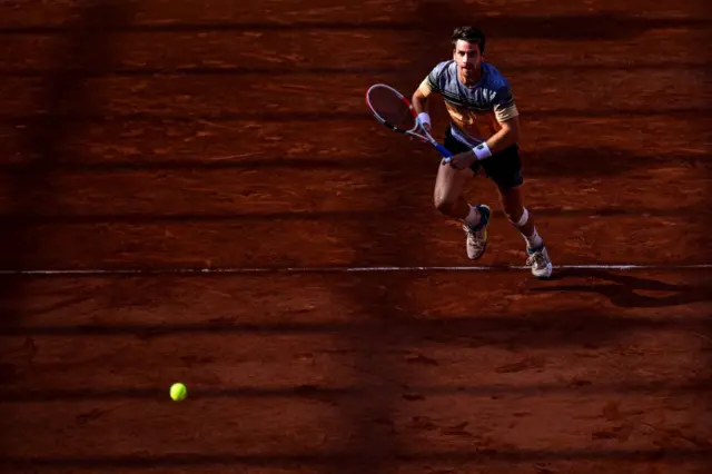 Cameron Norrie chases down a ball