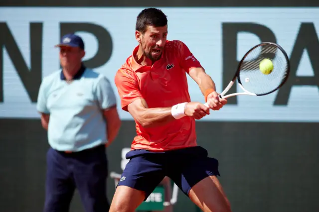 Djokovic hits a backhand shot