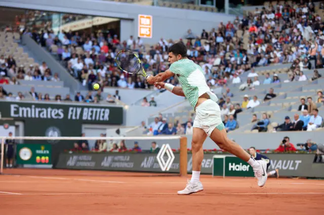 Carlos Alcaraz hits a backhand