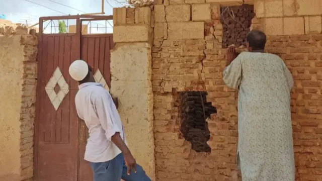 People check a damaged house as deadly shelling and gunfire resumed after the end of a 24-hour ceasefire in Sudan - 12 June