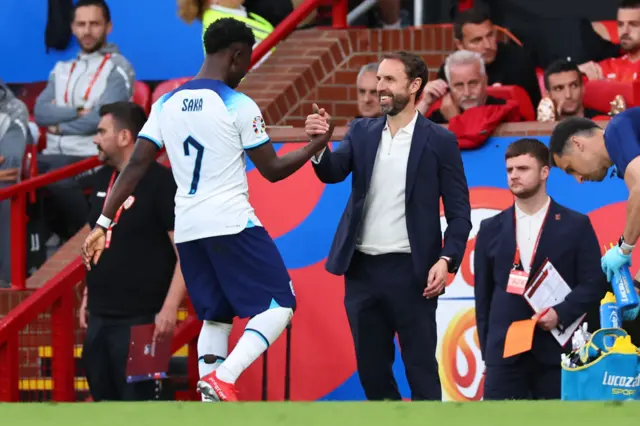 Bukayo Saka and Gareth Southgate exchange a handshake