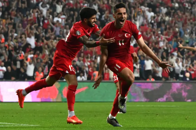 Turkey's Mehmet Umut Nayir celebrates with teammate Eren Elamli