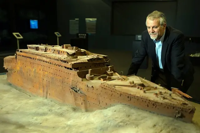 Paul-Henry Nargeolet poses next to a miniature version of Titanic at Paris Expo on May 31, 2013