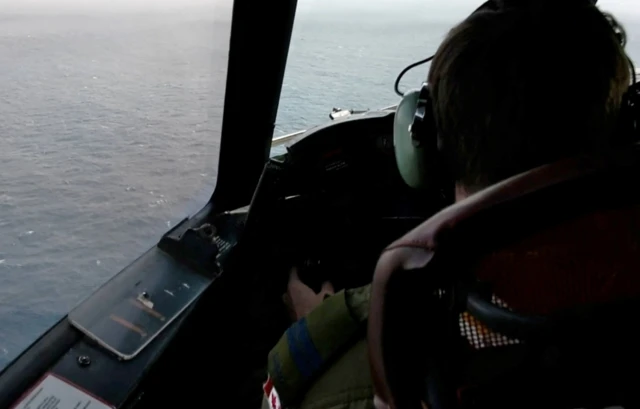 A Royal Canadian Air Force CP-140 Aurora maritime surveillance aircraft of 14 Wing flies a search pattern for the missing OceanGate submersible