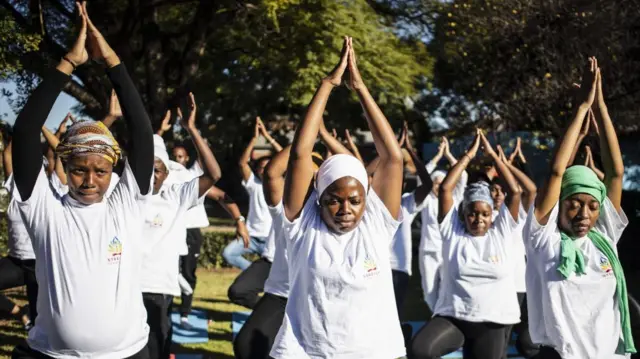 People practice yoga in the early morning at a venue on the outskirts of the Alexandra township on International Yoga Day in Johannesburg, South Africa, 21 June 2023