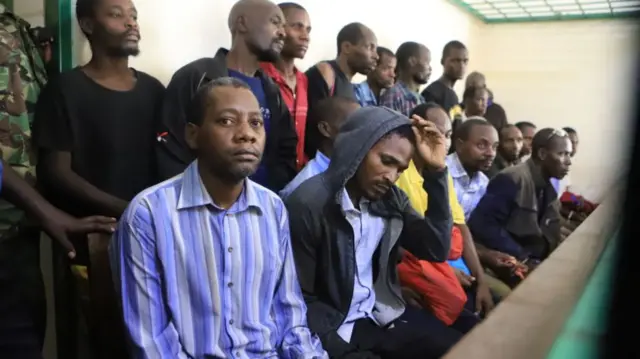 Paul Mackenzie (in the stripy shirt) and 29 other suspects in court in Kenya - June 2023