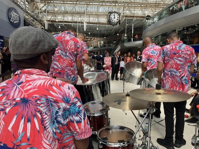 A band in front of a crowd at Waterloo Station