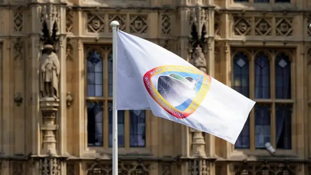 The Windrush flag flies at the Houses of Parliament, Westminster,