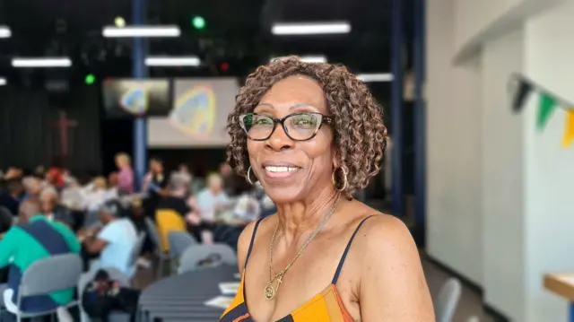 Lorna smiles to camera as she attends the Bradford Windrush anniversary