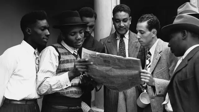 Caribbean passengers reading a newspaper on board the ship