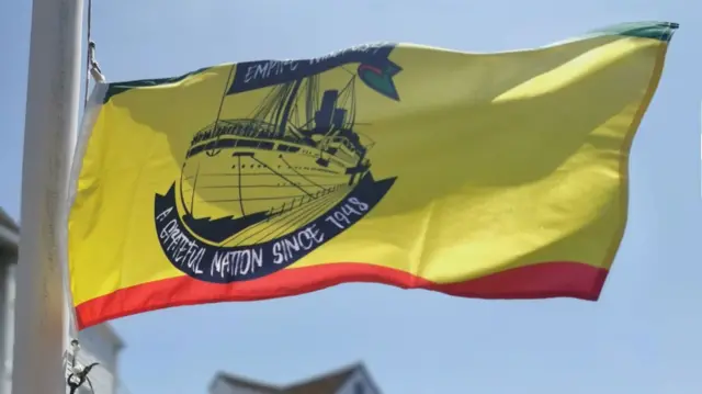 A Windrush anniversary flag being flown in Woodbridge, Suffolk