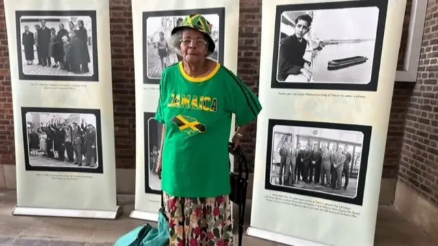 Paulette dons a Jamaican T-shirt and hat