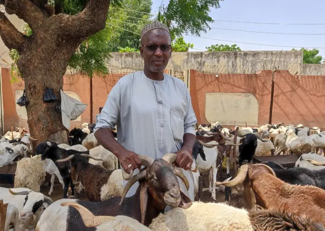 Owner of a four-horned ram at a market in Kano, Nigeria - 21 June 2023