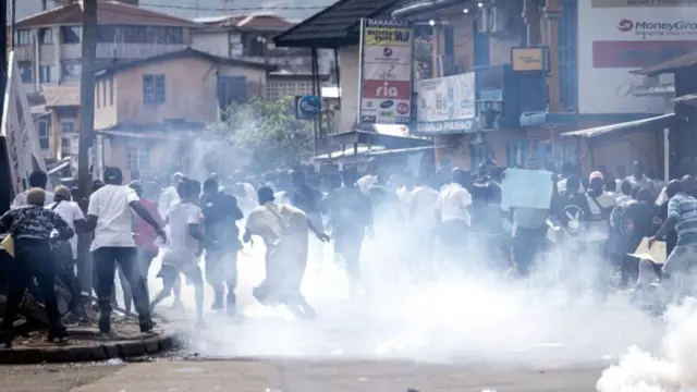 People run from teargas in Freetown, Sierra Leone - 21 June 2023