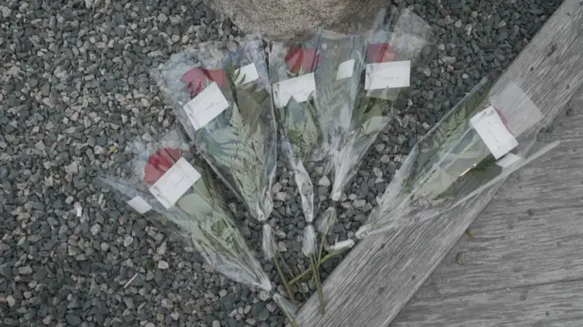 Roses with tags bearing the names of the five Titan sub victims