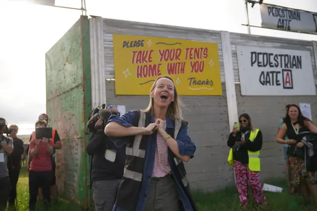 Emily Eavis grins outside the gates of Glastonbury on the first day