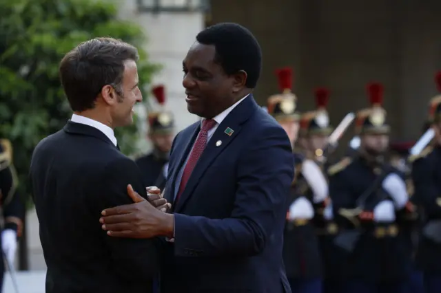 French President Emmanuel Macron (L) shakes hands to greet Zambia's President Hakainde Hichilema upon arrival for an official dinner at the Elysee Palace, on the sidelines of the New Global Financial Pact Summit, in Paris, on June 22, 2023. on June 22, 2023 in Paris, France