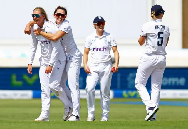 England's Sophie Ecclestone celebrates with teammates after taking the wicket of Australia's Kim Garth