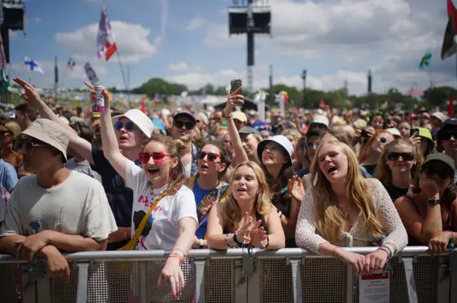 People cheering on the front row of a set at Glastonbury