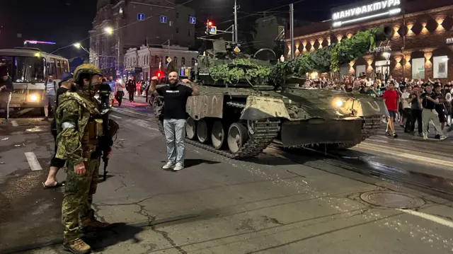 People gather to bid farewell to fighters of Wagner private mercenary group, who pull out of the headquarters of the Southern Military District and return to base, in the city of Rostov-on-Don