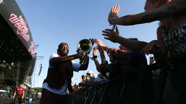 Trumpet player touching fans