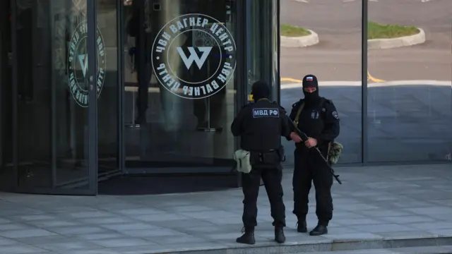 Officers outside the Wagner Group headquarters in St Petersburg