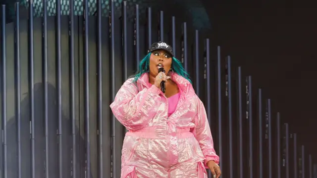 Lizzo in a pink jumpsuit