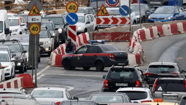 A law enforcement officer stands guard at a road block on the outskirts of Moscow