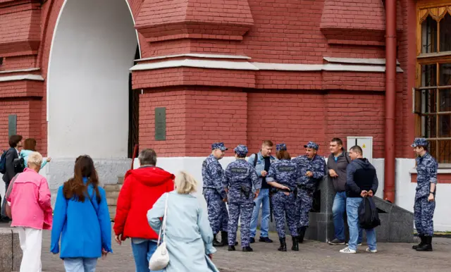 Law enforcement officers stand guard near the closed Red Square in Moscow