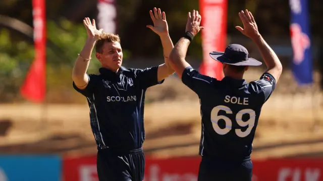 Brandon McMullen celebrates his wicket with Chris Sole