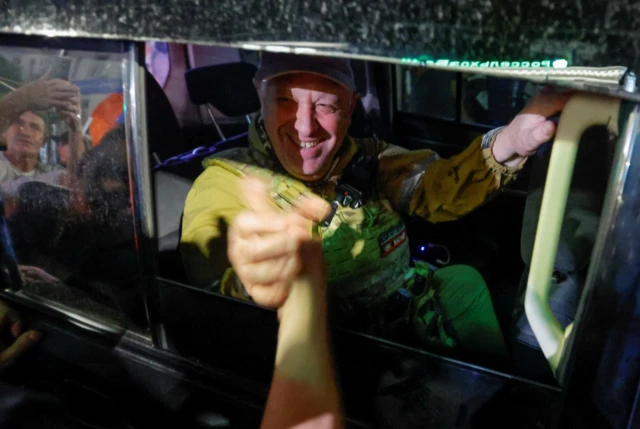 Yevgeny Prigozhin clasping hands with supporters as he and his group left the southern city of Rostov-on-Don on Saturday night