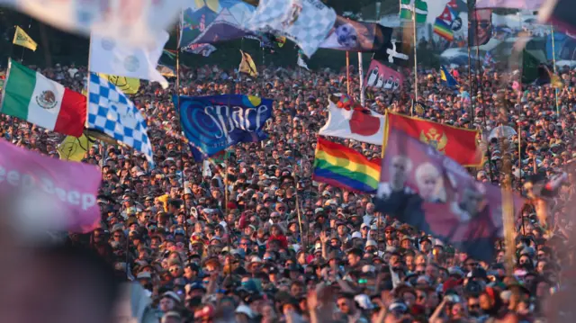 Crowds wait for Elton John to play the headline set on the Pyramid Stage