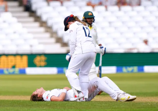 England's Tamsin Beaumont speaks to Nat Sciver-Brunt as she lies injured on the ground during day four of the first Women's Ashes test match at Trent Bridge, Nottingham