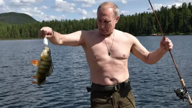 Vladimir Putin pictured shirtless whilst fishing in Siberia