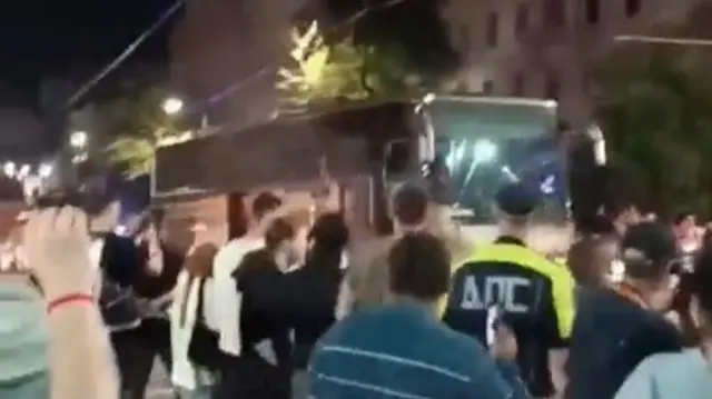 Crowds watch on as a busload of Wagner fighters leave Rostov-on-Don