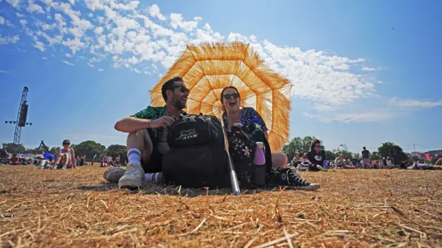 Festivalgoers during the hot weather at the Glastonbury Festival at Worthy Farm