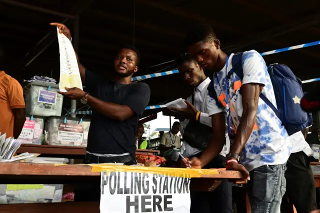 Election workers count ballots at a polling station, after polls closed, on the day of the national election, in Freetown, Sierra Leone, June 24, 2023