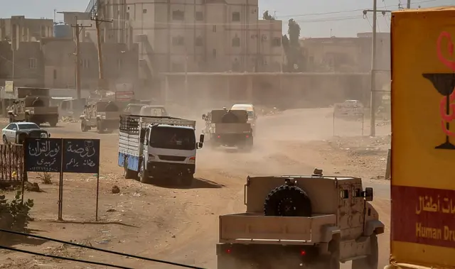 Sudanese army armoured vehicles drive in a street in Khartoum, on June 26, 2023.