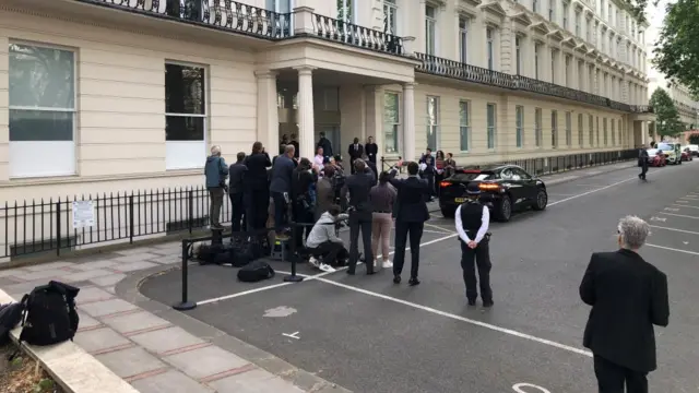 Protestors flank the steps to the inquiry