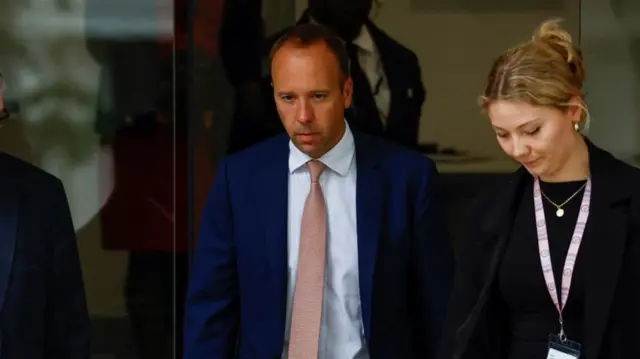 Matt Hancock leaves the inquiry next to an unidentified woman