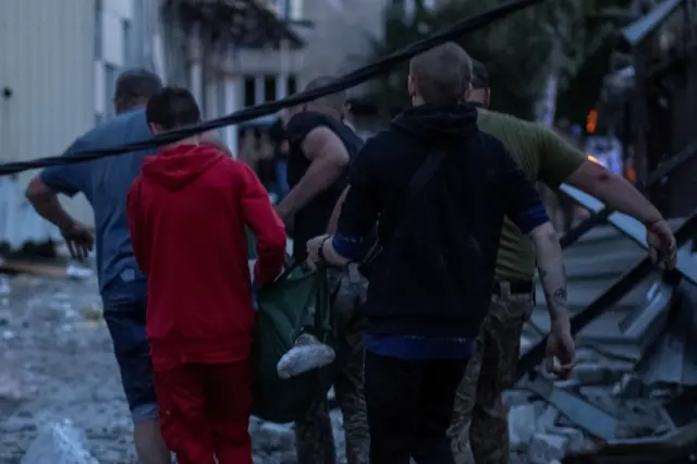 Volunteers carry an injured person