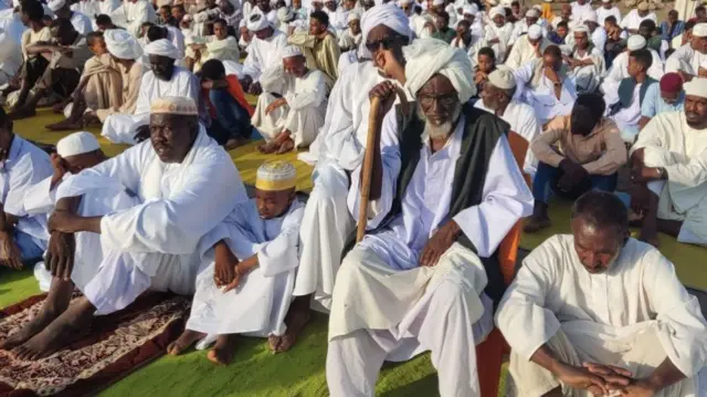 Muslim worshippers listen to the Eid Al-Adha prayer sermon in Sudan's eastern Gedaref region, on June 28, 2023.