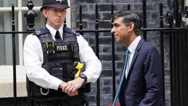 Rishi Sunak walks along Downing Street