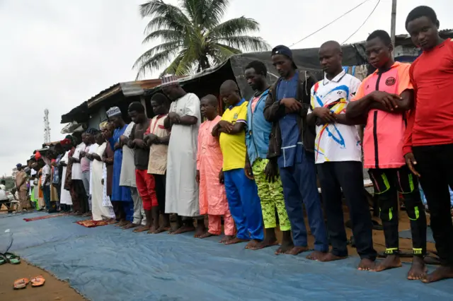 Muslims perform Eid Al-Adha prayers along the road at Ibafo in Ogun State, southwest Nigeria, on June 28, 2023