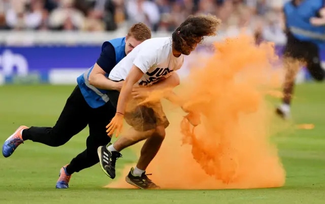 A steward tackling a Just Stop Oil protestor