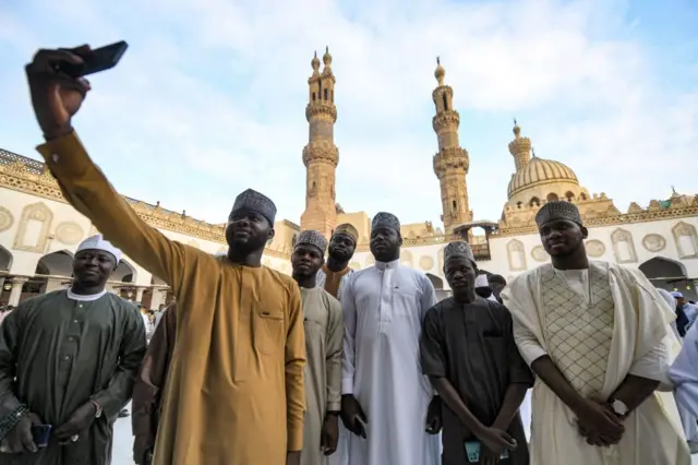 Muslim women worshippers pose for a "selfie" photo on a phone after the morning prayers for Eid al-Adha at the historic Azhar mosque in the centre of Cairo - 28 June  2023