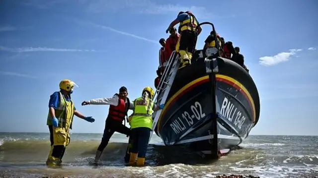 Asylum seekers leaving a RNLI lifeboat