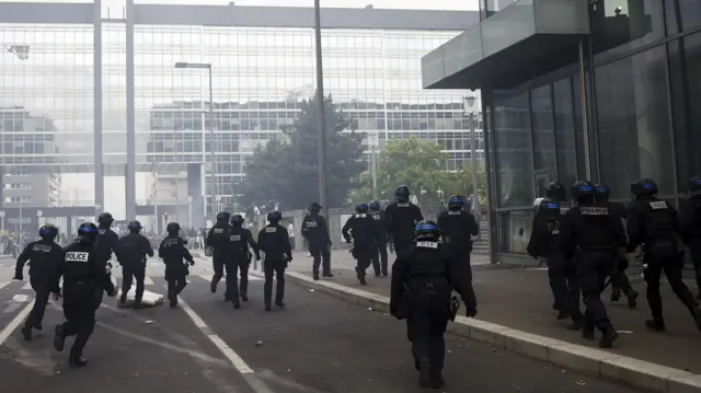 French riot police run through clouds of tear gar in Nanterre